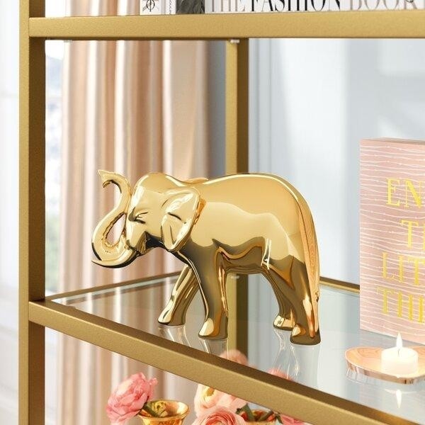 Керамическая фигура слона золотого цвета.jpeg