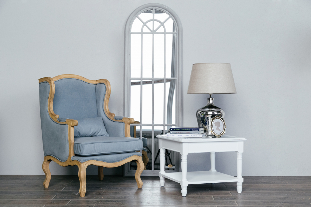 напольное арочное зеркало в гостиной с голубым классическим креслом